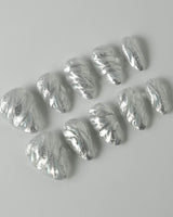 Velvet Frost press-on nails in extra short almond shape — 3D Spiral Texture, Silver Glitter Effect.