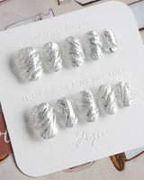 Velvet Frost press-on nails in extra short oval shape — 3D Spiral Texture, Silver Glitter Effect.