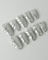 Velvet Frost press-on nails in medium almond shape — 3D Spiral Texture, Silver Glitter Effect.