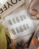 Velvet Frost press-on nails in short oval shape — 3D Spiral Texture, Silver Glitter Effect.