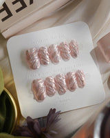 Velvet Twist press-on nails in short oval shape — Pink silver chrome swirl 3D sculpted glitter overlay