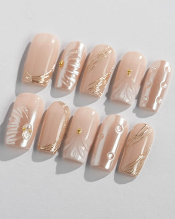 Venus medium square nails with pearl nude color, shell art, and gold accents