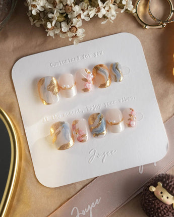 Vintage Mist press-on nails with elegant marble swirls, raised pearl accents and gold foil
