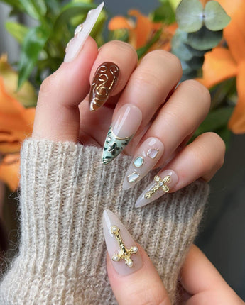 Vintage V nail art close-up showing Vintage Oil Painting Style, 3D Cross & Gemstones. details