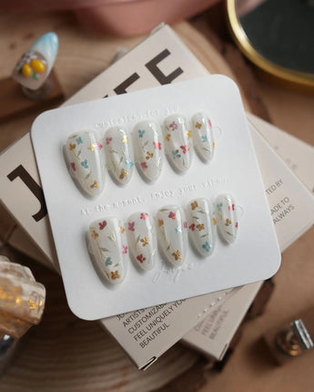 Wildflower press-on nails in short almond shape — Fresh Creamy White, Colorful Metallic Dainty Florals & Gold Wire Stems.
