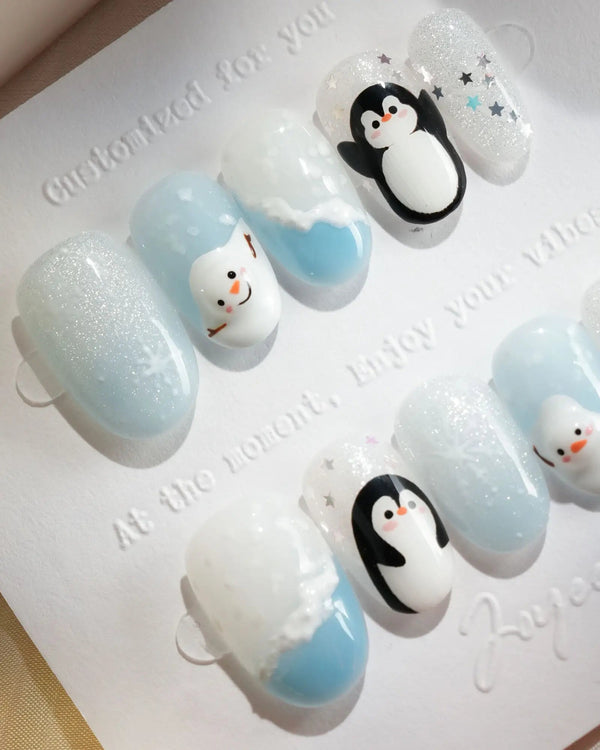 Winter penguin press-on nails with snowman and snowflake details