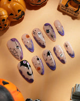 Witching Hour press on nails with a black spider web, bats, ghost, black cat and jack-o'-lanterns on a nude base with purple glitter edges - image 4