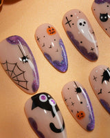 Witching Hour press on nails with a black spider web, bats, ghost, black cat and jack-o'-lanterns on a nude base with purple glitter edges - image 2