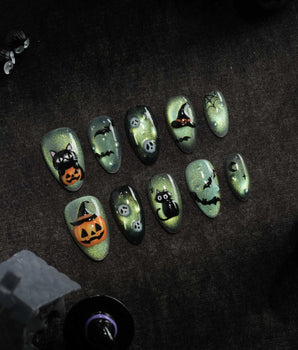 Witch's Cat press on nails with a black cat on a jack-o-lantern, witch hat, skulls, bats and a spider web on green shimmer cat eye - image 1