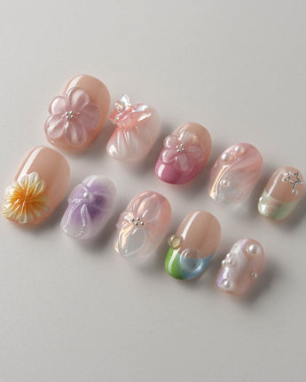 Wonderland Whims extra short oval nails with pastel floral art and delicate pearl shine
