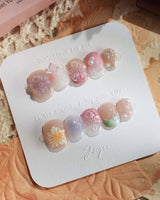 Wonderland Whims extra short squoval nails with pastel pink flowers and pearl accents