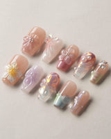 Wonderland Whims short coffin nails with soft pink 3D blossoms and glossy pearl details