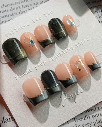 Woodland Sea in extra short coffin shape with green cat-eye French tips and shell glitter