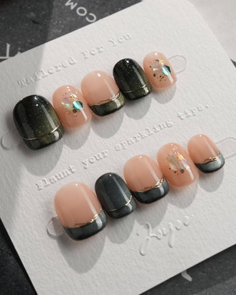 Woodland Sea press-on nails in extra short squoval shape — Dark Green Cat Eye, French Gold Line & Shell Glitters.