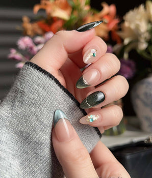 Woodland Sea press-on nails with dark green cat-eye shimmer, gold French lines, and shell glitter
