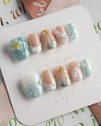 Yasawa Blue starlit shore nails with blue-white shimmer, pearls, and sculpted shells