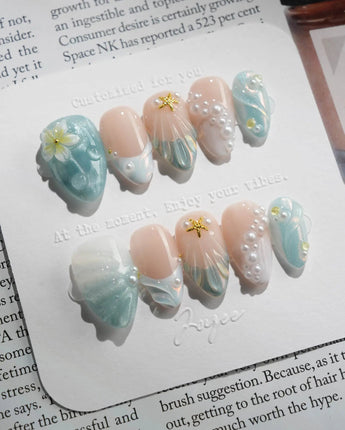 Yasawa Blue close-up of pearl beachcore nails with blue-white cat-eye shimmer