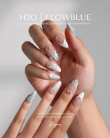 Yasawa Blue medium almond nails with jelly blue tones, 3D shells, pearls, and starfish
