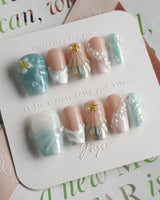 Yasawa Blue short coffin nails with shell-like swirls, pearl details, and blue shimmer