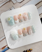 Yasawa Blue short oval nails with pearly ocean tones and gold starfish charm